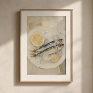 May include: A framed art print featuring a still life of two sardines on a white plate with lemon slices. The painting has a textured, impressionistic style with a neutral color palette, perfect for kitchen or dining room decor.