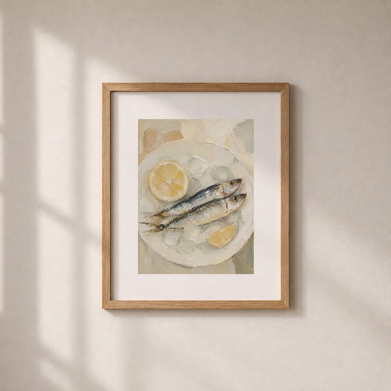 May include: A framed art print featuring a still life of two sardines on a white plate with lemon slices and ice. The painting has a neutral color palette with a focus on the food.