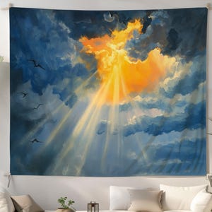 May include: A large wall tapestry depicting a dramatic sky scene. The artwork features a vibrant orange and yellow sunburst breaking through dark blue and gray clouds. Rays of light stream downwards, with silhouettes of birds in flight.