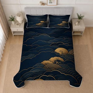 May include: A bedding set featuring a dark navy blue quilt and two matching pillowcases. The fabric displays a repeating pattern of stylized golden clouds and circular wave motifs, with a thin white border outlining the edges of each piece.