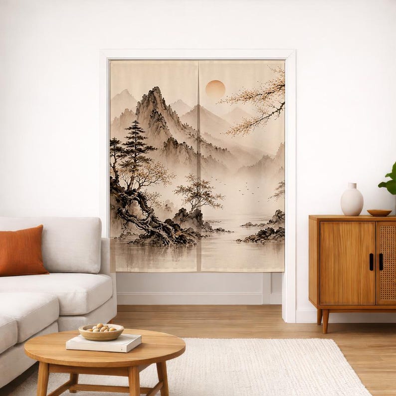 May include: A split-panel fabric door curtain featuring a sepia-toned landscape illustration of jagged mountains, a calm body of water, and stylized pine trees. A large, pale sun hangs in the sky above the misty, layered mountain peaks.