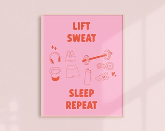 May include: Pink framed print with the words "LIFT SWEAT SLEEP REPEAT" in orange. The print features orange line drawings of workout equipment, including headphones, a sports bra, a barbell, shorts, a water bottle, a shoe, and a kettlebell.
