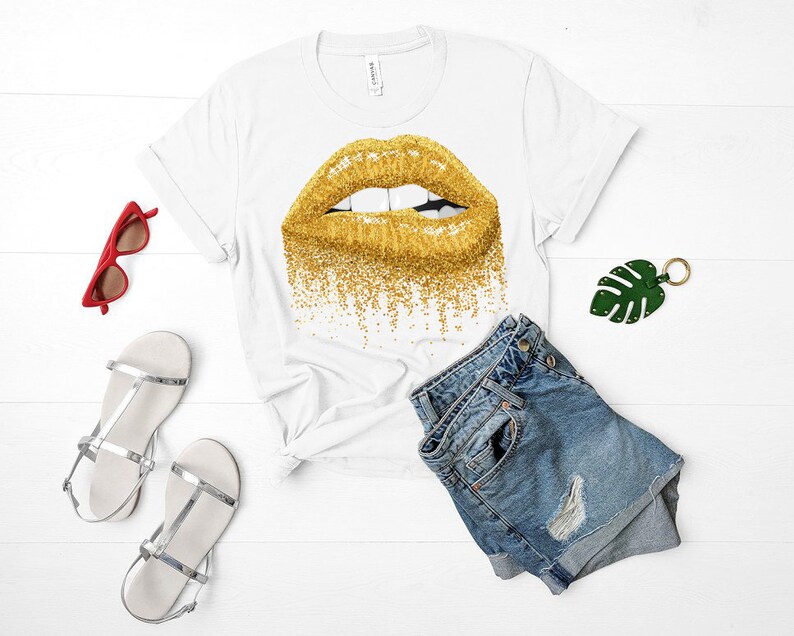 May include: White t-shirt with a gold glitter lip print. The shirt is paired with blue denim shorts.