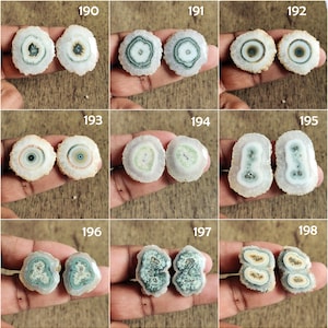 May include: Nine pairs of agate slices with different patterns and colors, including white, green, and brown. The agate slices are arranged in a grid pattern.