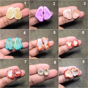 May include: Nine pairs of polished geode slices in various colours are displayed. The geodes show pink, orange, green, and white hues. Each pair is held in a hand, highlighting the unique patterns and crystal formations within the geodes.