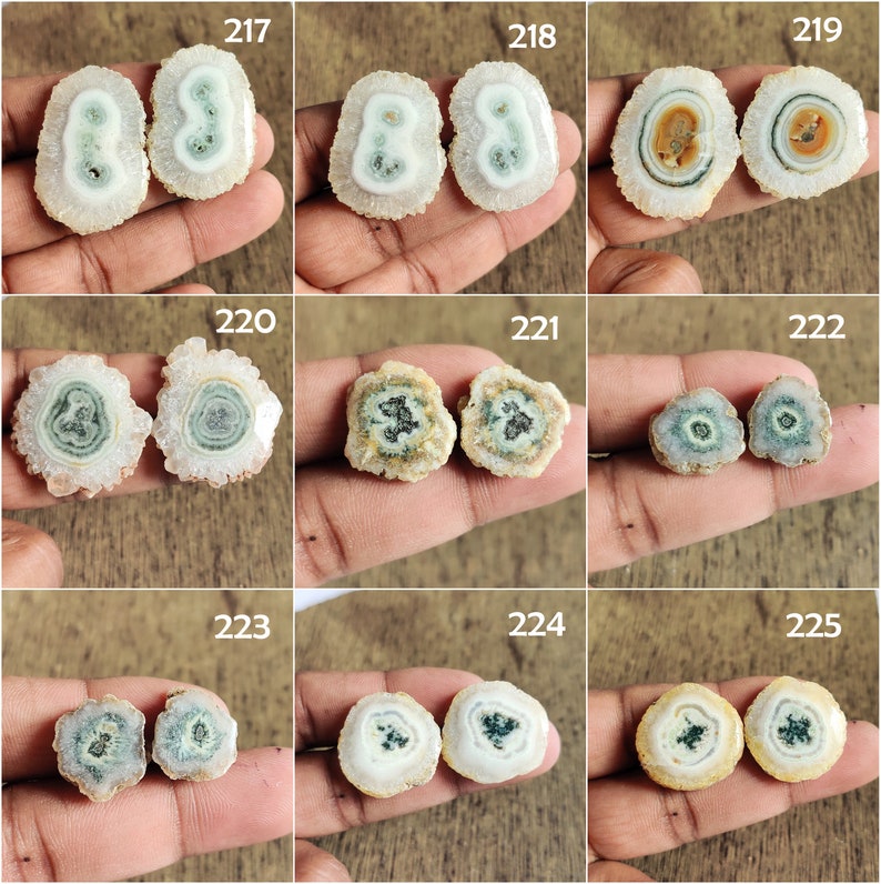 May include: A set of 10 pairs of agate slices, each pair featuring a unique pattern of concentric circles in shades of white, brown, and green. The slices are approximately 1 inch in diameter and have a smooth, polished surface.