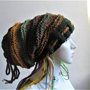 May include: A green, orange, and brown knit beanie with long, colorful yarn strands hanging from the bottom.