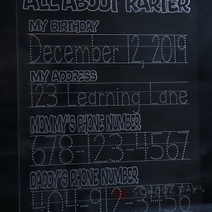 May include: A white plastic board with black text and dotted lines for tracing. The text reads "All About Karter", "My Birthday", "December 12, 2019", "My Address", "123 Learning Lane", "Mommy's Phone Number", "Daddy's Phone Number", and "School Days".