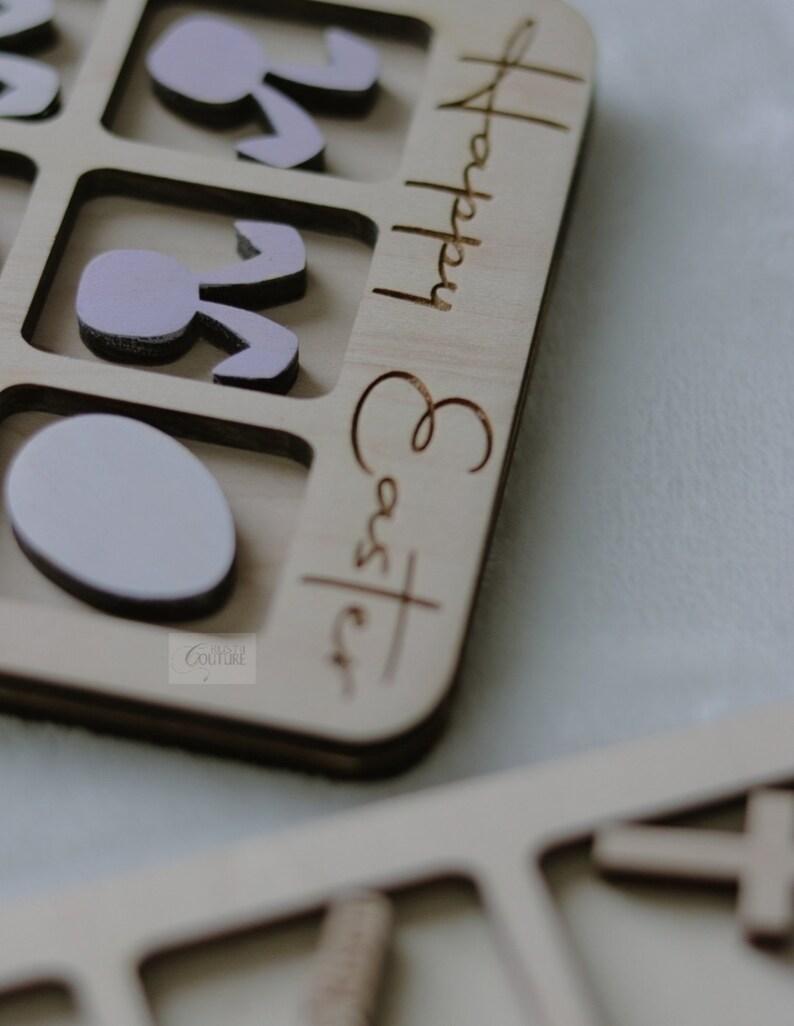 May include: Wooden puzzle with a light pink bunny and egg shapes. The puzzle is labeled "Happy Easter".