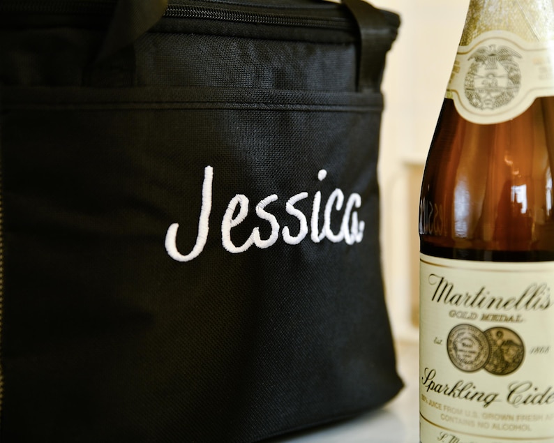 Pu&ograve; includere: Una borsa termica nera con chiusura a zip e un nome ricamato in bianco "Jessica".
