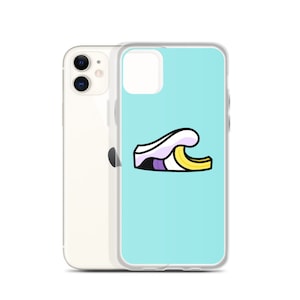May include: A clear phone case with a light blue background and a cartoon wave design. The wave is white, purple, black, and yellow. The phone case is on top of a white iPhone.