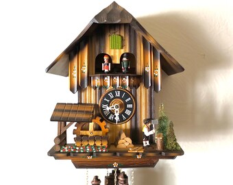 WORKING Vintage, musical “Wood Cutter Chalet” style cuckoo clock. Made in Germany in 1986. Moving wood cutter and dancers! 1 year warranty!!