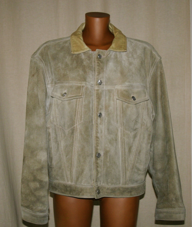 May include: A light brown suede jacket with a button-up front and a corduroy collar.