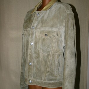 May include: A light brown suede jacket with a light brown leather collar and silver buttons.