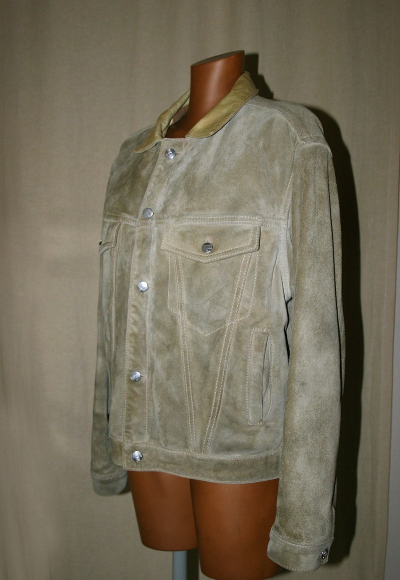 May include: A light brown suede jacket with a light brown leather collar and silver buttons.