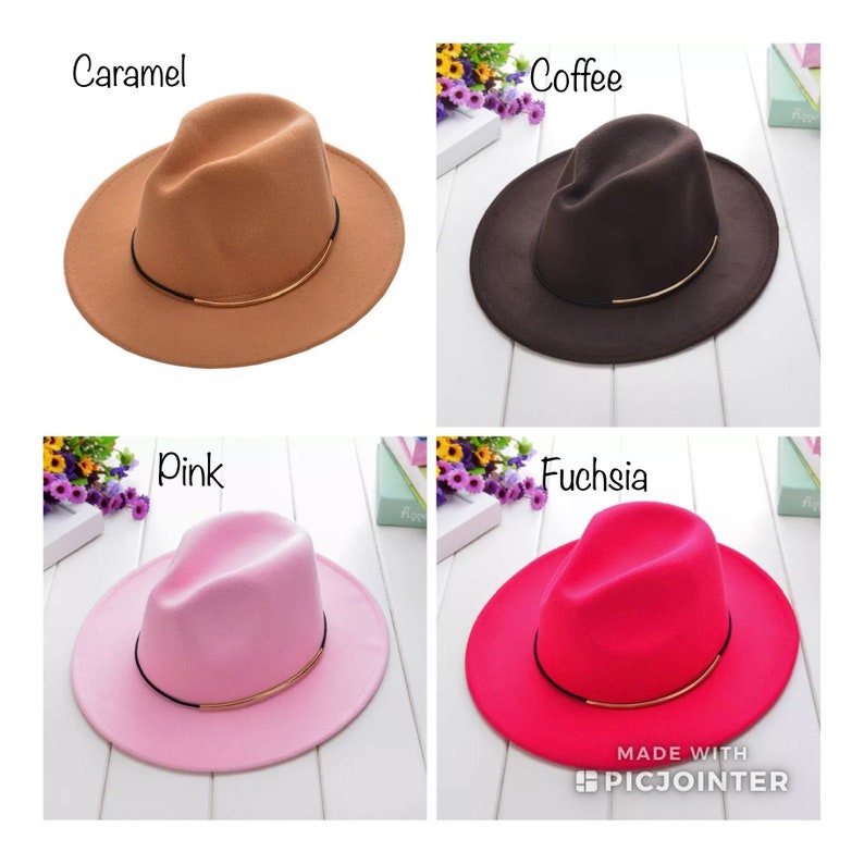 May include: Four felt fedora hats in different colours: caramel, coffee, pink, and fuchsia. Each hat has a thin gold band around the crown.