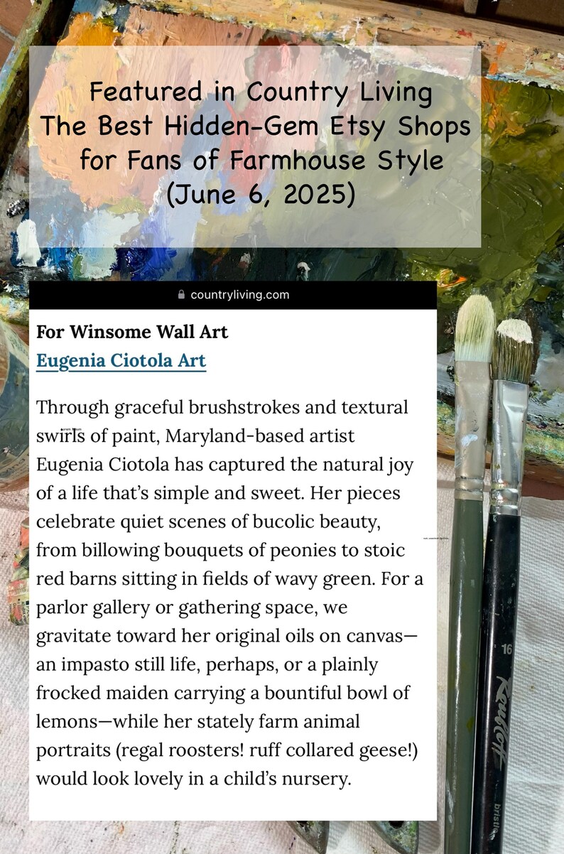 May include: A digital screenshot of a Country Living article featuring Eugenia Ciotola Art, overlaid on a wooden palette with colorful oil paint smears and two paintbrushes with white bristles resting on the right side of the frame.