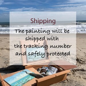 May include: A wooden portable art easel box containing several paint tubes and a palette knife, with a small landscape painting displayed on the easel stand. The box is open, revealing internal compartments for art supplies and tools.