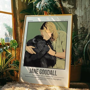 Puede incluir: Un póster enmarcado con marco dorado, que representa a Jane Goodall abrazando a un chimpancé. El póster incluye el texto "Jane Goodall" y "Primatologist and Anthropologist". El fondo es de color verde claro.