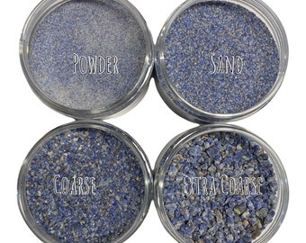 May include: Four glass jars containing different sizes of blue lapis lazuli powder, labeled "Powder", "Sand", "Coarse", and "Extra Coarse".