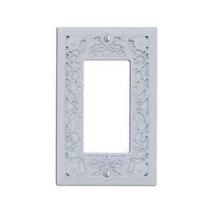 May include: White decorative wall plate with a single switch opening and an intricate floral design.