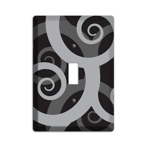 May include: A black and silver light switch cover with a swirling pattern.