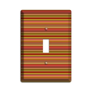 May include: A light switch cover with a colorful striped pattern in shades of red, orange, yellow, brown, and green.