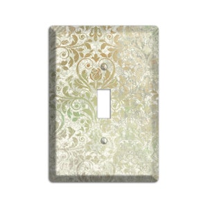 May include: A light switch cover with a vintage damask pattern in shades of green, gold, and white.