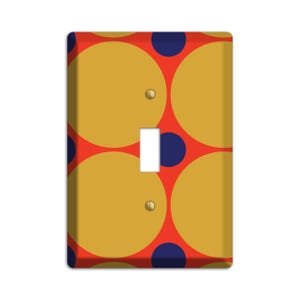May include: A light switch cover with a geometric pattern of overlapping circles in yellow, red, and blue.