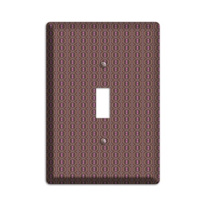 May include: A light switch cover with a geometric pattern in shades of brown, pink, and white.