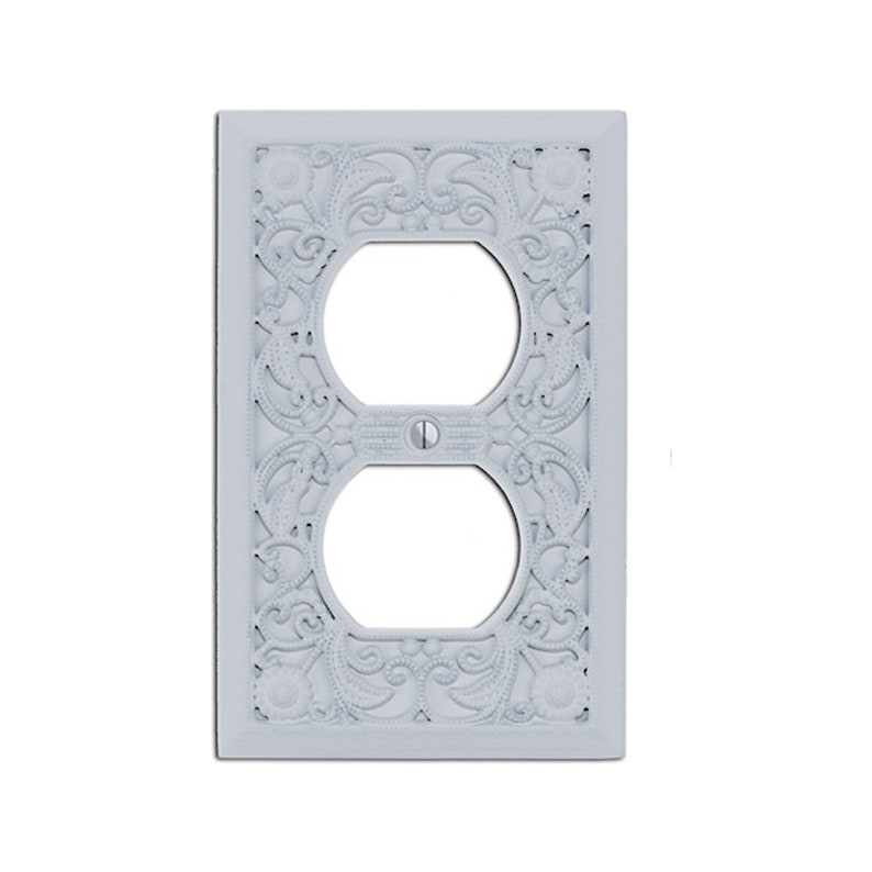 May include: White decorative outlet cover with an ornate, floral design.