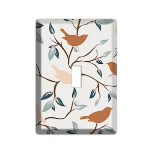 May include: Light switch cover with a pattern of brown and pink birds on branches with teal leaves.