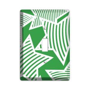 May include: Green and white light switch cover with a geometric pattern of stars and stripes.