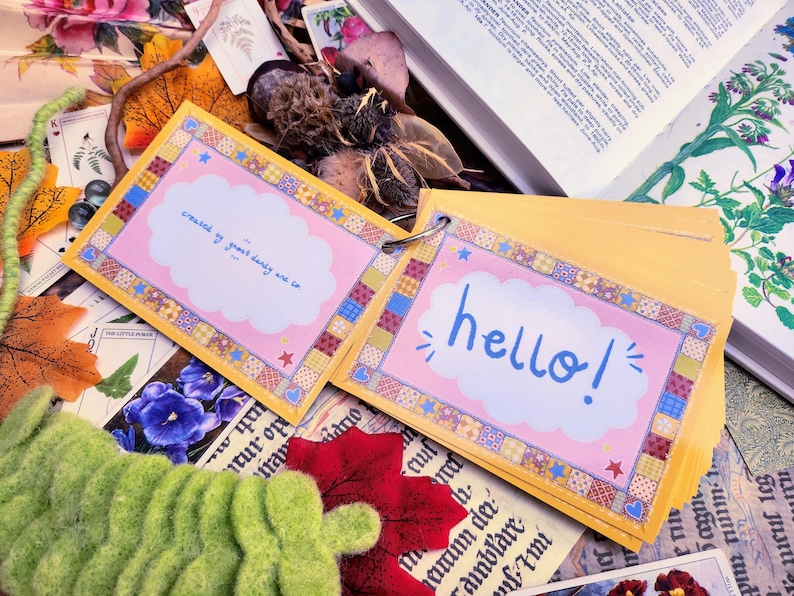 May include: A yellow and pink card with a cloud and the text "creased by guard dandy are co" and another yellow and pink card with a cloud and the text "hello!"