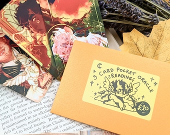 May include: A yellow envelope with a sticker that says "3 Card Pocket Oracle Reading" and features a cartoon angel with wings. The sticker also has a price tag that says "£10".