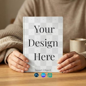 May include: A white book cover with the text "Your Design Here" in a bold, black font. The cover has a grid pattern and the words "Smart Object" are at the bottom. The book is held by a person.