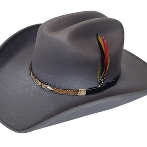 May include: A gray felt cowboy hat with a brown leather band and silver accents. A colorful feather is attached to the hat.