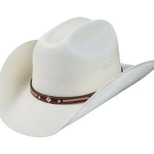 May include: A white cowboy hat with a brown leather band and silver accents. The hat has a wide brim and a tall crown.