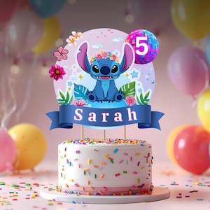 May include: A birthday cake with a blue and white theme. The cake is topped with a blue character, flowers, and a banner that says "Sarah". The cake is decorated with colorful sprinkles and surrounded by balloons.