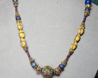 Gold finished brass, and an enameled bead