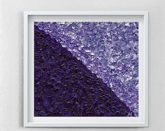 May include: A contemporary living room with a framed abstract artwork in shades of purple. A grey armchair with a yellow cushion is positioned below the art. A second yellow cushion lies on the floor, adding a bright accent.