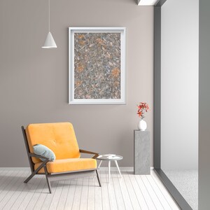 May include: A yellow armchair with a light blue throw pillow sits in a modern living room with a white side table and a framed abstract painting on the wall. A potted plant with red flowers sits on a gray pedestal.