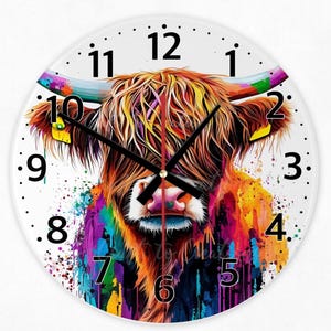 May include: A circular wall clock with a colourful illustration of a Highland cow. The cow's fur is rendered in vibrant shades of orange, yellow, purple, and blue. Black clock hands indicate the time against a white background with black numerals.