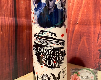 May include: White stainless steel tumbler with a black and white image of three men, a car, and the words "Carry On My Wayward Son". The tumbler also has a red splatter pattern and a black and white image of a winged heart with a pentagram.