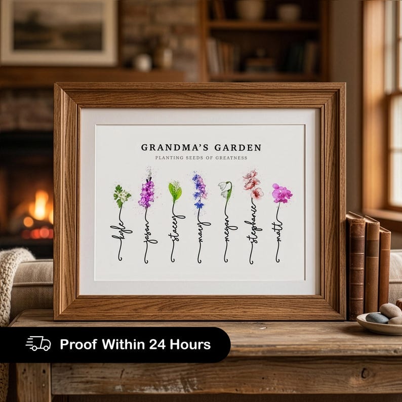 Grandma's Garden personalized birth flower print in a wood frame with white mat, propped on a table in a warm living room with a lit fireplace and books. Subtitle reads Planting Seeds of Greatness. Seven watercolor birth month flowers, including hawthorn, gladiolus, lily of the valley, larkspur, snowdrop, cherry blossom and sweet pea, grow from hand-lettered stems that spell each grandchild's name. A sentimental grandma gift from the grandkids.