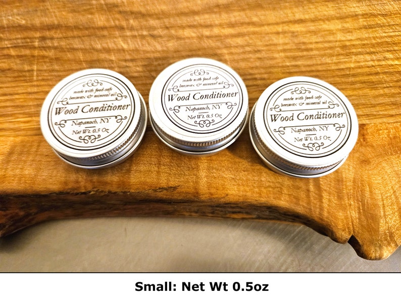 May include: Three small, round, silver-colored metal tins of wood conditioner, each with a white label featuring black text that reads Wood Conditioner, Napanoch, NY, and Net Wt 0.5 oz, along with a description of food-safe beeswax and mineral oil.