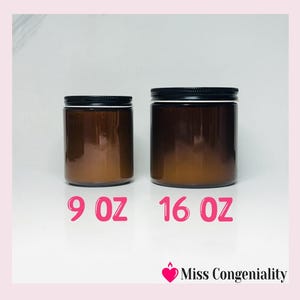 May include: Two amber glass candle jars with black lids. The smaller jar is labeled 9 oz and the larger jar is labeled 16 oz.