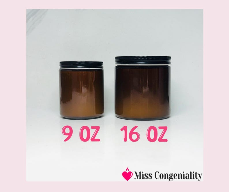 May include: Two amber glass candle jars with black lids. The smaller jar is labeled 9 oz and the larger jar is labeled 16 oz.