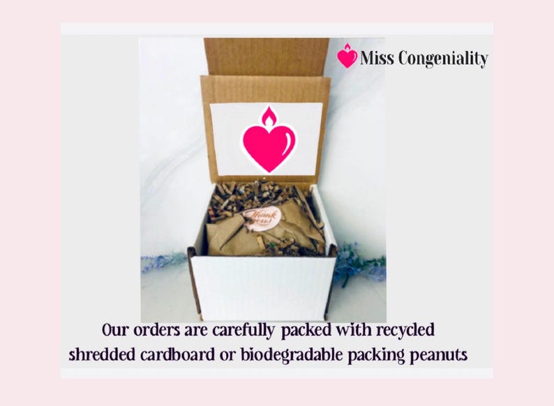 May include: A white box with a brown lid is open, revealing shredded paper inside. The box has a pink heart with a flame on top and the text "Miss Congeniality" on the lid. The text "Our orders are carefully packed with recycled shredded cardboard or biodegradable packing peanuts" is below the box.