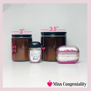 May include: Three glass jars with black lids. The jars are 3.5 inches tall and 3 inches wide. The middle jar is 4 inches tall. A small clear plastic bottle with a black lid and a label is in front of the jars. A pink and white glitter-filled case is in front of the jars.